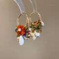 Bohemian drop tassel earrings with orange flower and white stone detail on clear stands - Style 14 Silver Post