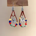 Close-up of Bohemian teardrop earrings with colorful beads and floral pendants - Style 20 Ear Hook
