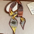 Detailed view of a vintage paisley printed silk scarf necklace styled in warm earth tones. - Style 4 (HN10385) / Coffee-Yellow