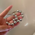 Minimalist silver-tone hoop earrings featuring large polished metallic beads decoration. - Small Twisted Style (6#) / Silver