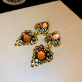 Macro view showing the intricate detail of vintage palace style gold earrings with colorful gemstones - Earring Post Style - Triangle (17#)