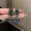 Close-up of vintage Baroque style blue crystal drop earrings with gold emerald accents - Clip-on Style - Geometric (18#)