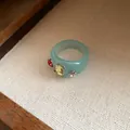 Macro view of light blue chunky resin ring featuring red and yellow rhinestones - Light Blue