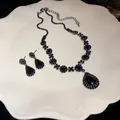 Detail shot of the black rhinestone teardrop pendant necklace and matching earring set - Necklace and Earrings (Gunmetal-Black)
