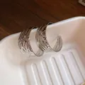 Elegant silver-tone hammered hoop earrings featuring a unique irregular ripple texture. - Water Ripple Hammered with Steel Earring Post (128#) / Silver