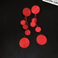 Detailed view of red lacquered circular tassel earrings with S925 silver needle - Red