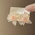 Close-up of transparent resin flower earrings with pink centers on a display card - Transparent Flower (218#)