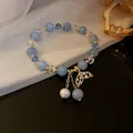Handcrafted light blue bead bracelet featuring a sparkling mermaid tail charm and pearl detail. - Blue Fish Tail Style (20)