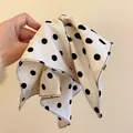 Macro detail view of white fabric-wrapped hair claw clip featuring large black polka dots - White Polka Dot
