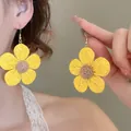 Close-up detail showing the intricate woven texture of yellow sunflower earrings - Style 7 Ear Hook