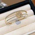 Close-up of elegant double-layer open bangle with sparkling zircon rose motif design - Flower Open Bangle (HB5095) / Gold