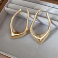 Macro view of minimalist irregular geometric gold-plated earrings in a velvet tray - Irregular Geometric Hollow Earrings / Gold
