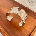 Detailed view of wide irregular silver cuff bracelet with liquid metal texture - Silver