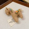 Handmade fabric horse brooch with colorful embroidered flowers on vintage linen background - Floral Embroidered Horse