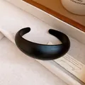 Detailed macro view showing the smooth matte texture of a minimalist black acrylic open bangle - Thick Rounded Style (2#) / Black