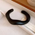 Detailed macro view of a matte black minimalist acrylic cuff bracelet with organic shape. - Irregular Organic Style (4#) / Black