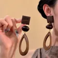 Detailed view of bohemian geometric wooden drop earrings featuring vintage brown wood textures - Geometric Three-Tier Silver Post / 7# Coffee Color