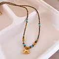 Ketting met hobbelpaard hanger en tijgeroog kralen in een elegante gouden uitvoering - Tijgeroog Schommelpaard Stijl (62#)
