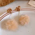 Detailed view of leopard print heart earrings with tan fur pom-poms for winter style. - Style 21 Long (Silver Post) / Coffee/Leopard