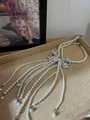 Close-up of French vintage pearl necklace with rhinestone bow on woven tray - French Vintage Bow Tassel (White)