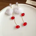 Close-up of elegant long dangle earrings with white fluffy pom-poms and red glass beads - 33# Silver Needle Style / White/Red