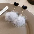 Close-up detail of stylish grey faux fur pom pom earrings with black velvet hearts. - Style 45 Long (Silver Post) / Black/Grey