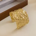 Close-up view of a gold-tone wide cuff bracelet with a creative crinkled metal texture - Circular Hammered Open Style (HB2654) / Gold