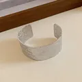 Close-up macro view of minimalist silver metal cuff bracelet with artistic hammered texture - Hammered Open Style (HB2653) / Silver