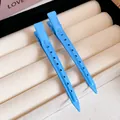 Close-up detail of two vibrant light blue duckbill hair clips on a beige jewelry display - 53# Duckbill Clip - Hollow Round Holes