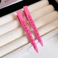 Close-up of vibrant pink matte metal duckbill hair clips on jewelry tray - 57# Duckbill Clip - Hollow Round Holes