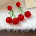 Handmade beaded cherry earrings with a soft red pom-pom top and green beaded stems. - 44# Silver Post Style / Red/Green