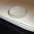 Detailed view of a luxury multi-layer pearl bracelet with rhinestones and elegant sheen - Triple Layer Style / Silver