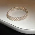 Detailed macro view of a three-layer gold open bracelet featuring pearls and sparkling crystals - Triple Layer Style / Gold