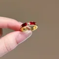 Dettaglio dell'anello d'oro con smalto rosso e fiori di zircone scintillanti - Stile Anello Smalto Rosso Vintage