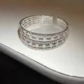 Close-up of multi-layer silver bangle with sparkling rhinestones and white pearls - Four Layer Style / Silver