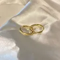 Elegant high-shine gold metal hoop earrings displayed on smooth white silk fabric - Simple Closed Style (22#) / Gold