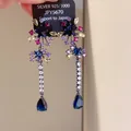 Close-up detail of multi-colored zircon star earrings with blue teardrop-shaped tassels - Multicolor (12#)