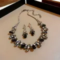 Detailed close-up view of elegant black water drop rhinestone necklace and earring set - Necklace and Earrings Set (HN5719) / Black