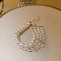 Elegant French style multi-strand white pearl bracelet with gold adjustable chain - Four Layered Style / White