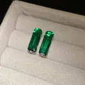 Close-up detail showing emerald green rectangular zircon stud earrings in a velvet box - Rectangular Cut Large (3#)