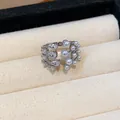 Detailed view of an elegant multi-layer open ring set with zirconia and lustrous pearls - Silver