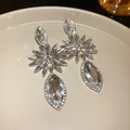 Detailed macro view of luxurious crystal-encrusted floral earrings with marquise stones - Silver Waterdrop Flower