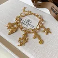Elegant gold plated charm bracelet featuring starfish, seashell, seahorse and octopus pendants - Bracelet / Regular Gold Style 15