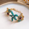 Vacation style gold bracelet with turquoise starfish, shells and pearls detail - Bracelet / Gold Blue Style 17