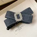 Detail showing the rhinestone buckle and fabric texture of this elegant bow hair clip - Twist Clip / Gray