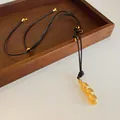 Elegant gold-tone peanut pod pendant necklace with black adjustable cord - Gold