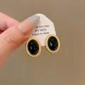 Vintage style black gemstone oval stud earrings with a textured golden rope border - Earrings / Gold-Black