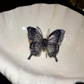 Detail view of a multi-layered 3D butterfly open ring with sparkling glitter wing edges. - Small / Black