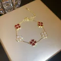 Macro detail of gold-plated bracelet featuring red and pavé zircon four-leaf clover motifs. - 22# Bracelet - Gold - Red (real Gold Plated)