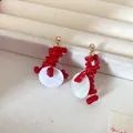 Detailed macro shot showing the vibrant red beads and white shell pendants of these earrings. - Red Beads with White Disc Style (HE27926)